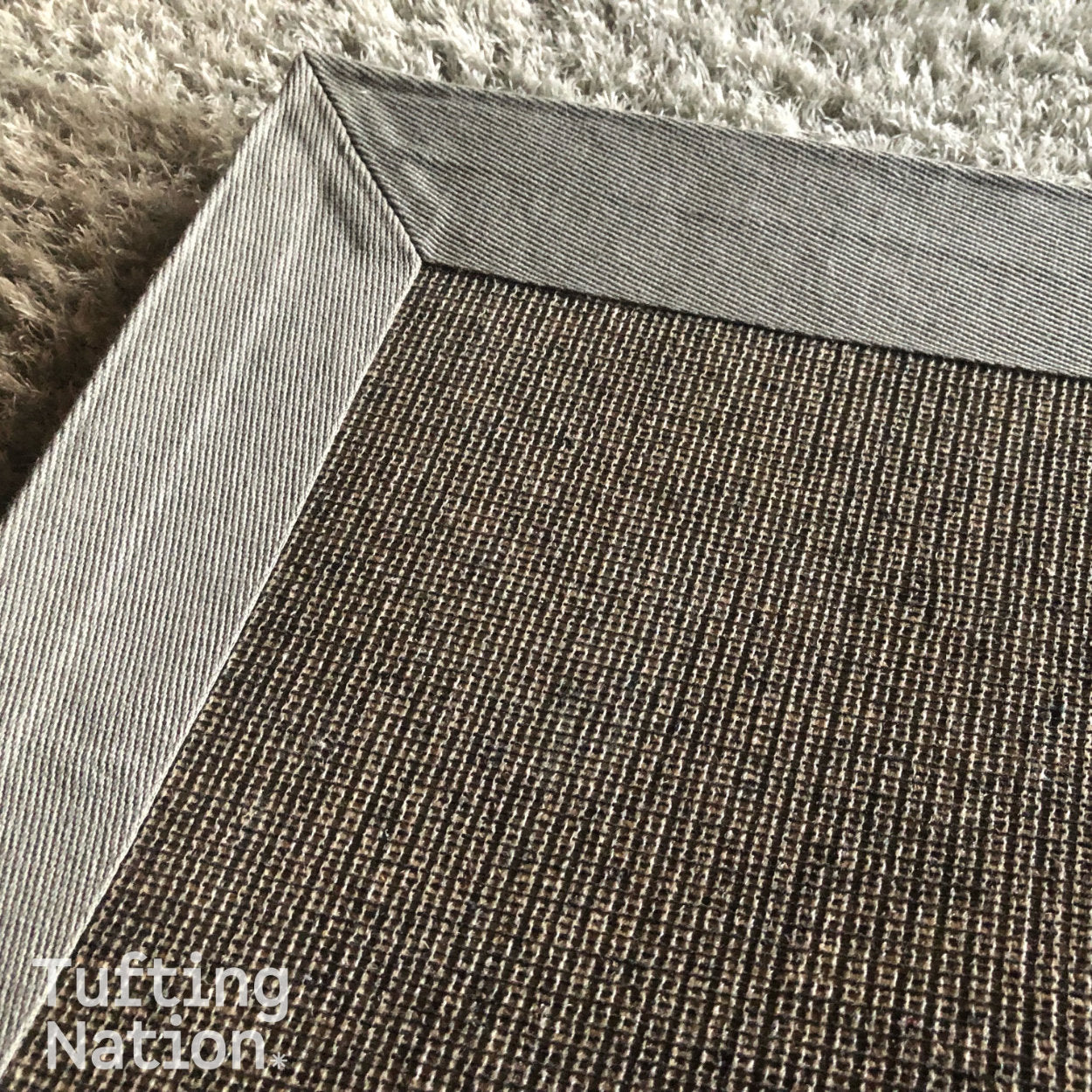 Back of a handmade rug finished with Rug Making Glue and binding tape  | TuftingNation