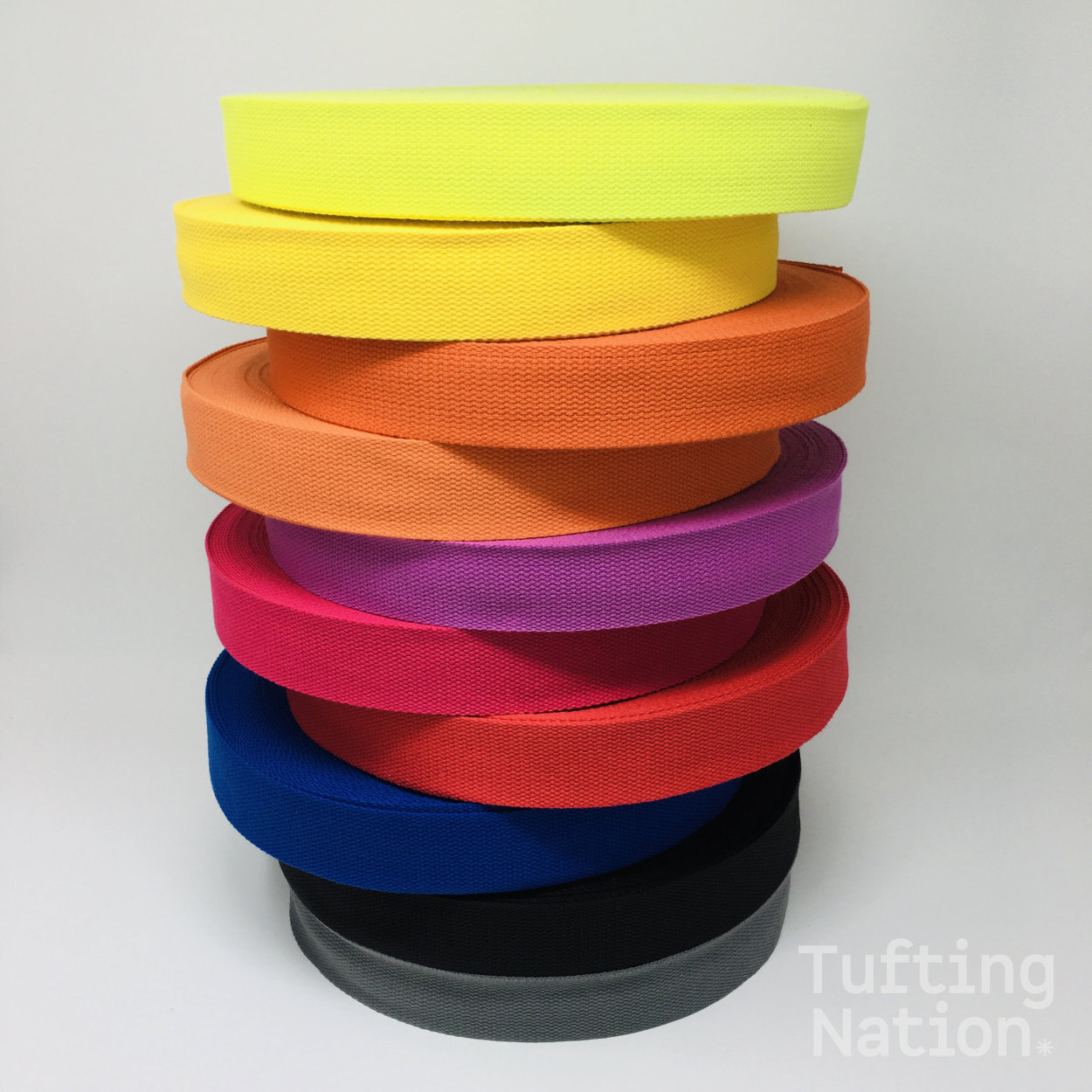 Pile of colorful binding tape for carpet finishing. 1.5 inch wide, 100% cotton twill tape at TuftingNation.