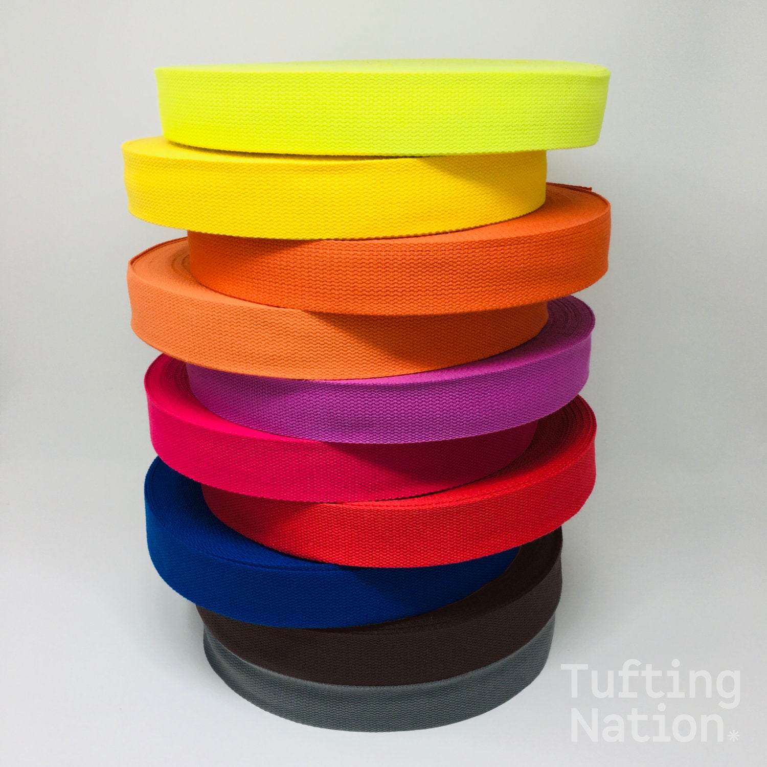 Pile of colorful binding tape for carpet finishing. 1.5 inch wide, 100% cotton twill tape at TuftingNation.