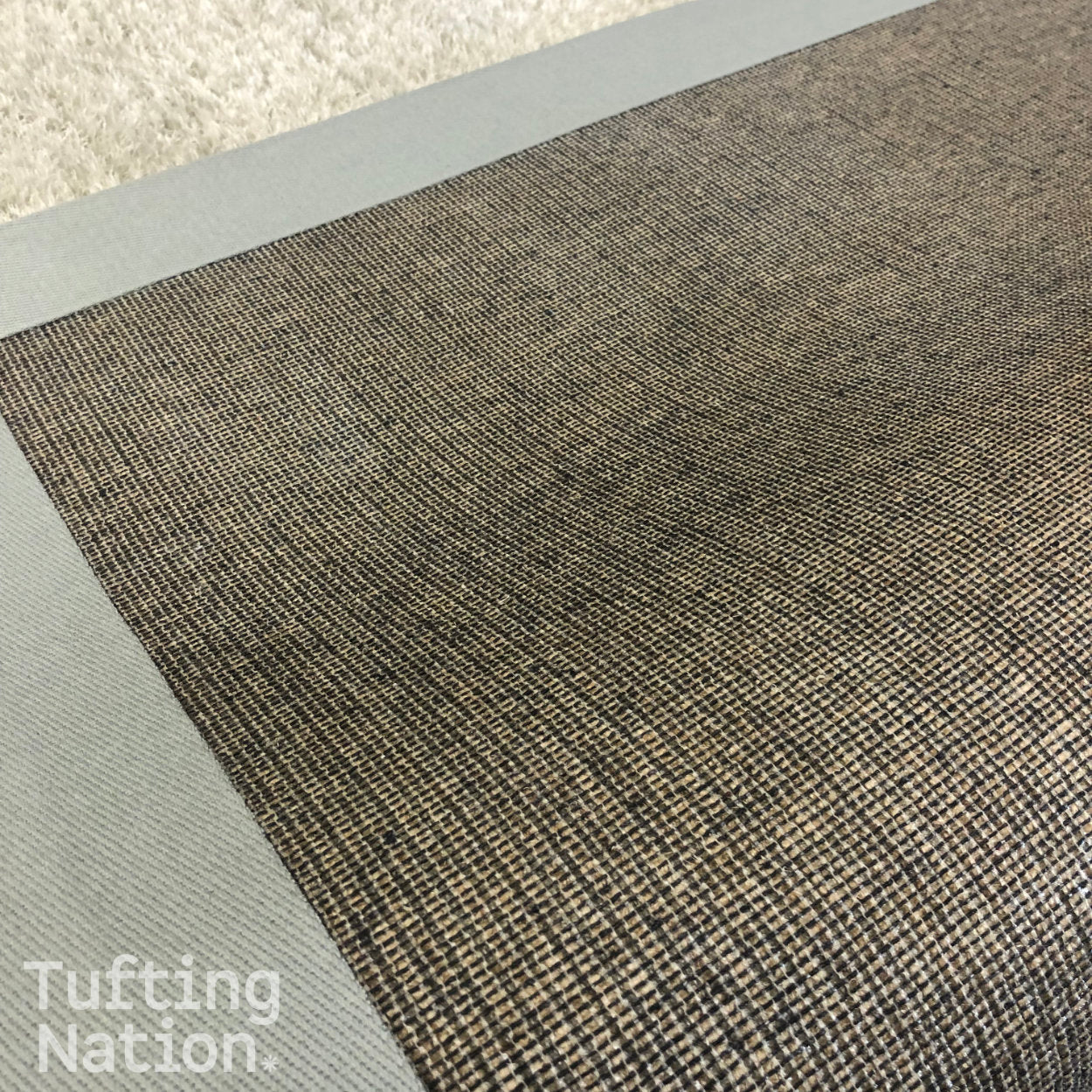 Back of a Handtufted Rug Finished with a Secondary Backing Cloth, Rug Glue and Binding Tape for the Edges | TuftingNation